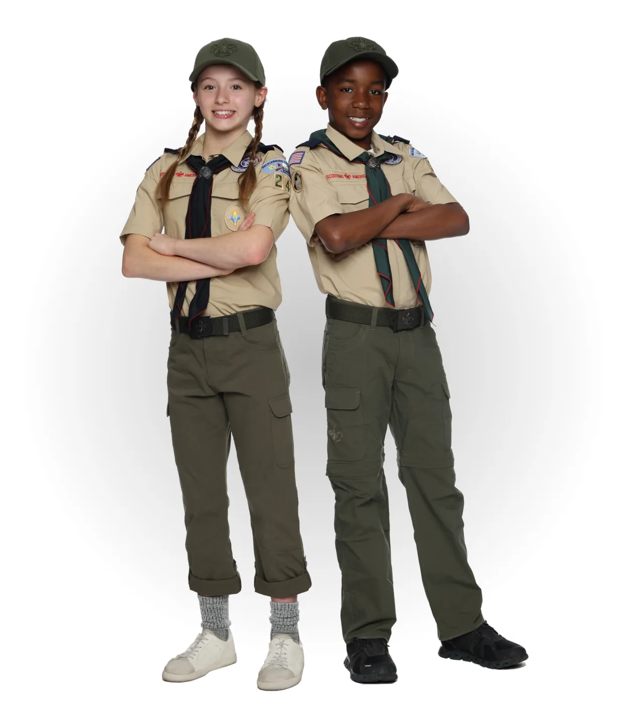 Two Arrow of Light Cub Scouts wearing tan shirts, green pants, green neckerchiefs, and green caps.