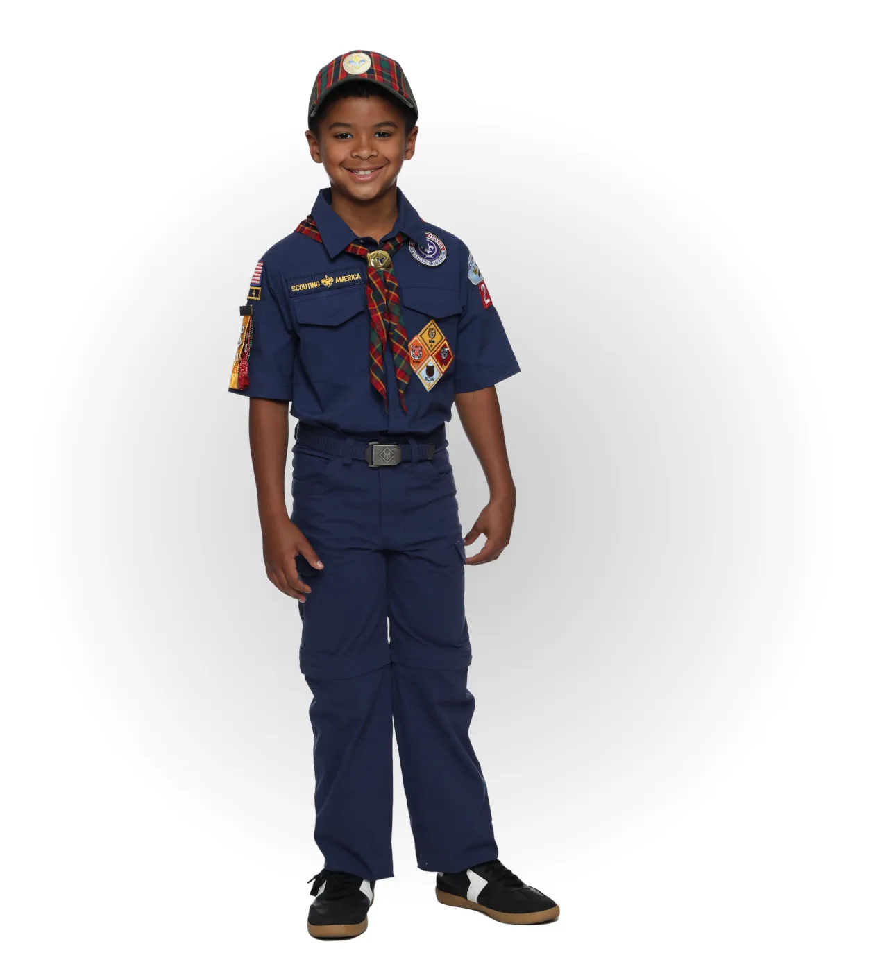 Webelos Cub Scout wearing a blue uniform with a plaid neckerchief and matching cap.