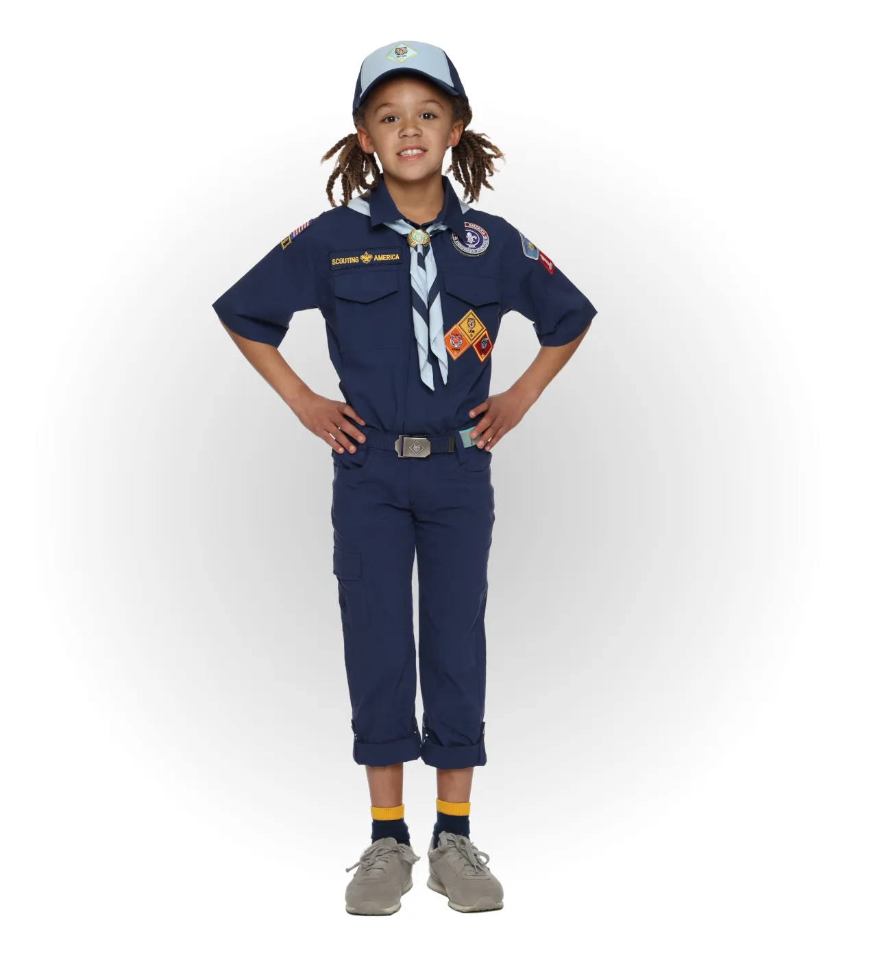 Bear Cub Scout wearing a blue uniform with a light blue neckerchief and matching cap.